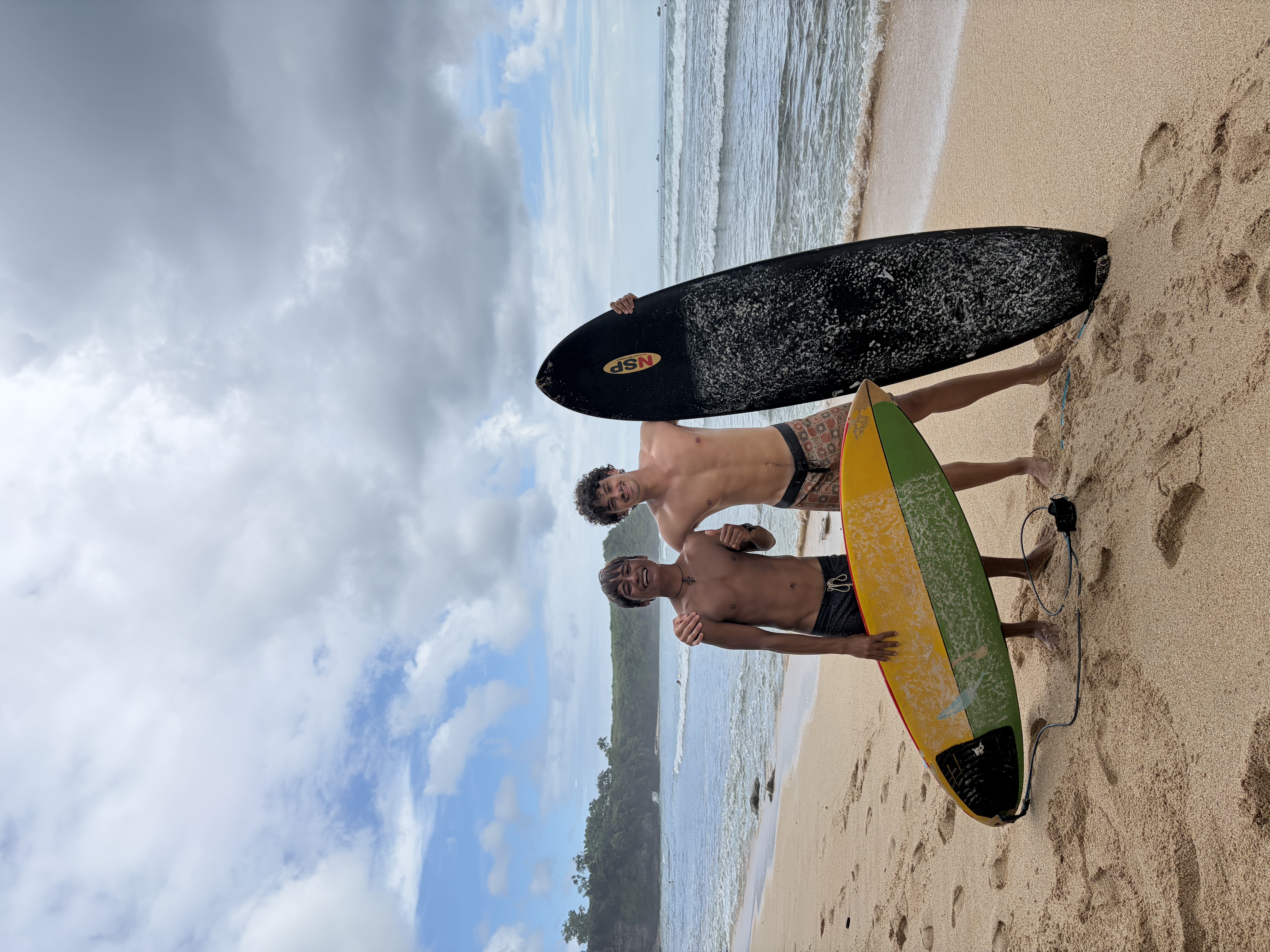 Kilian and Toba on the beach after a surf session in Uluwatu