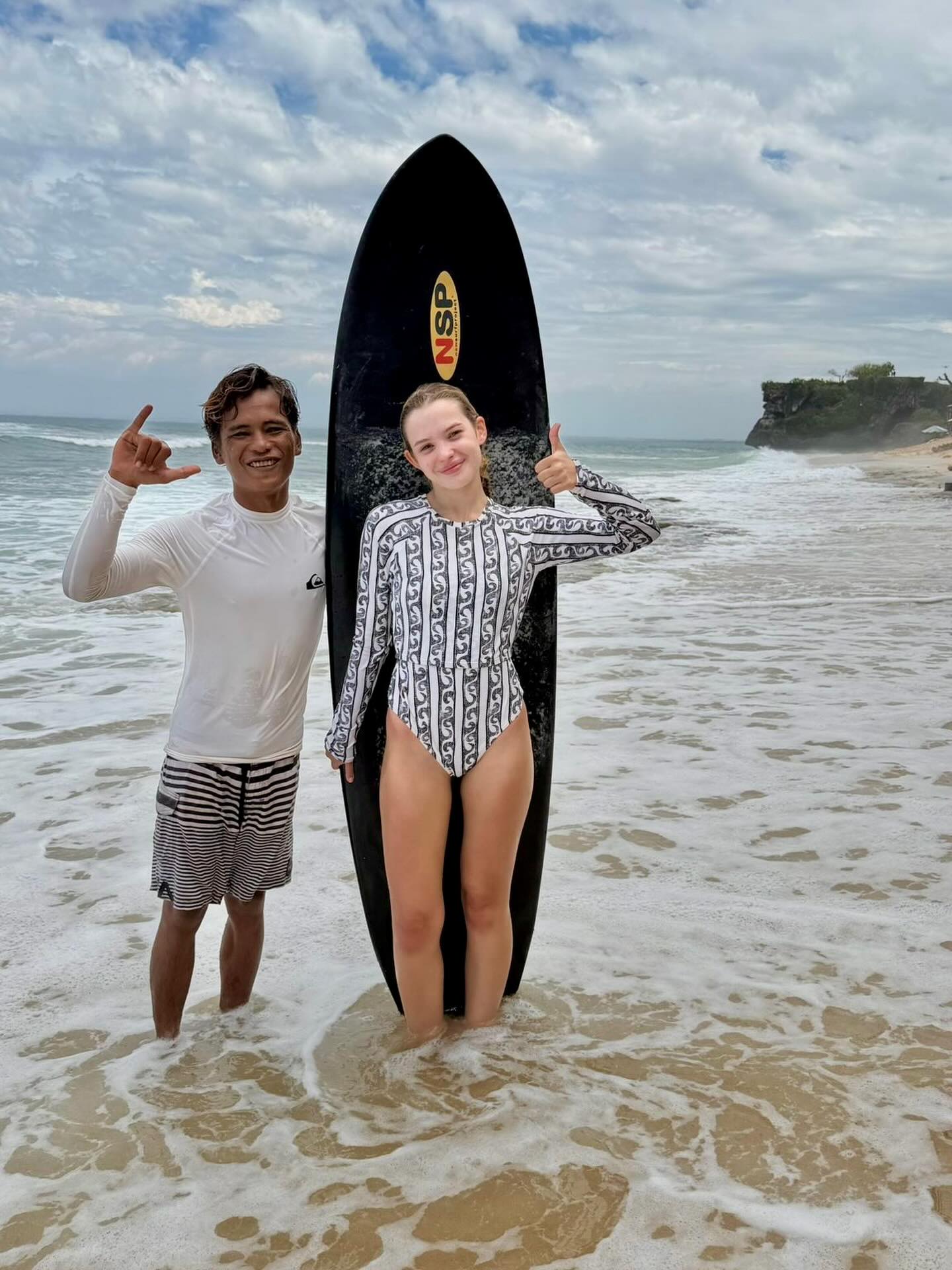 Tracey learning to surf with Toba in Bali