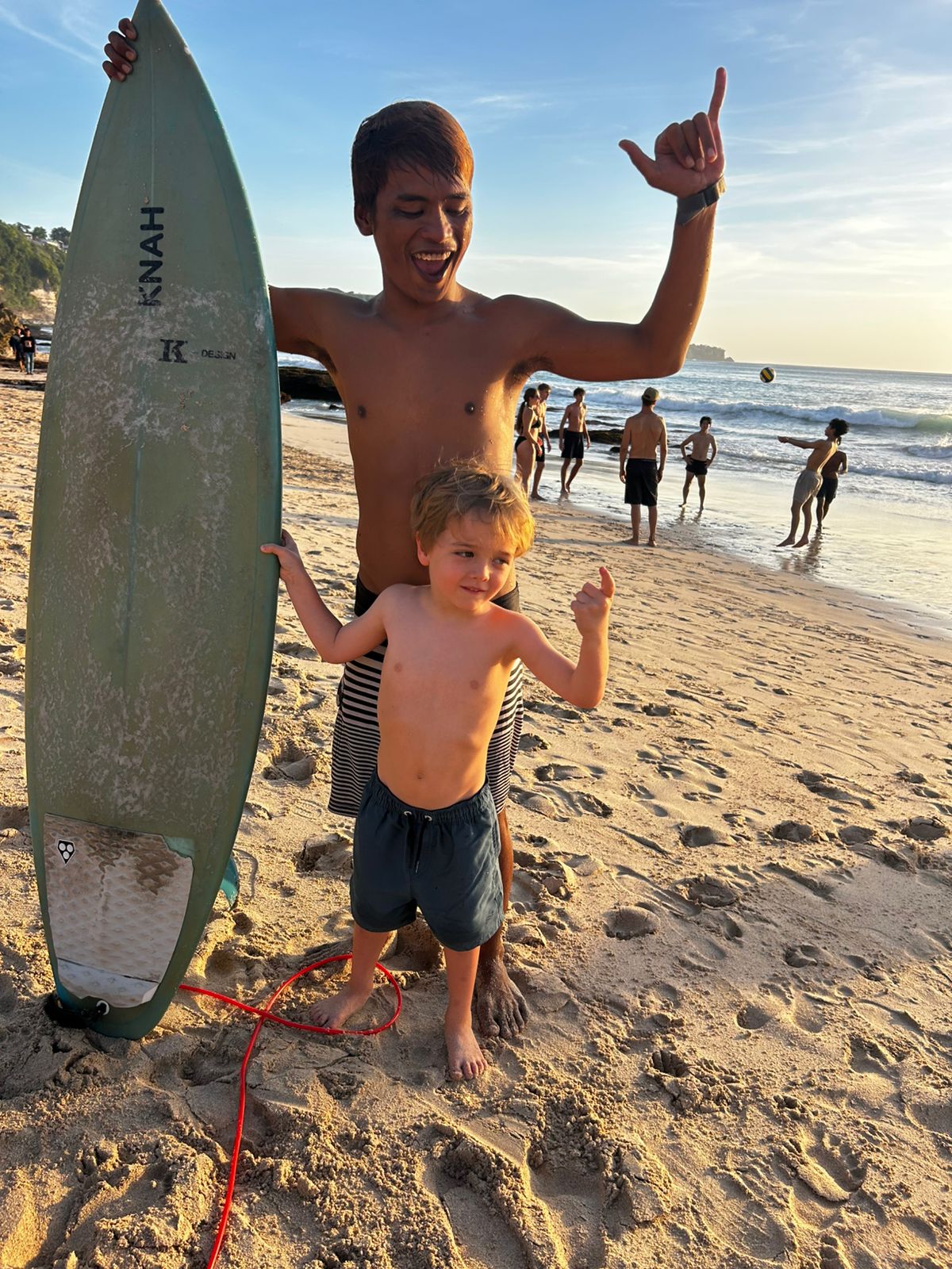 Toba on the beach with a young surf student